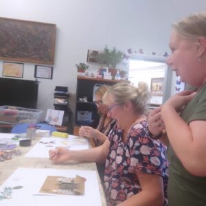Parent Art Therapy showing 2 parents and 1 art tutor laughing during an art activity
